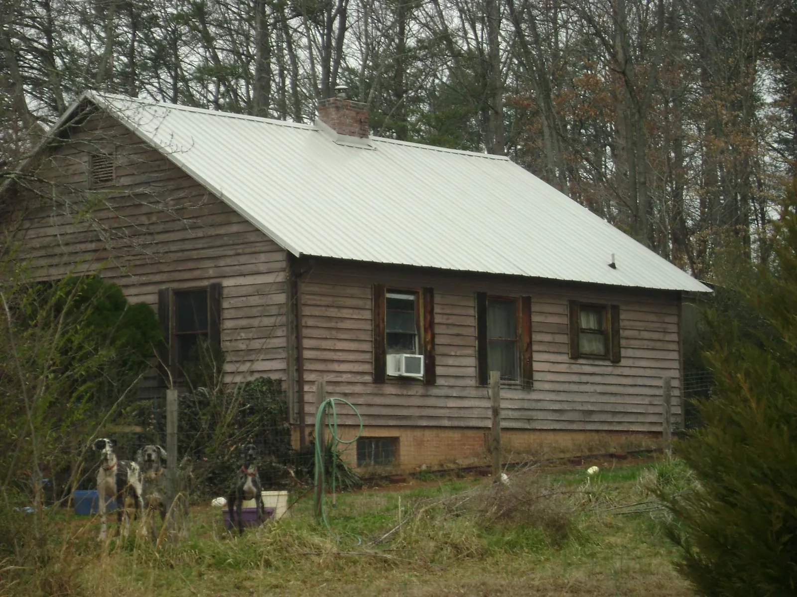 White metal roof on an old wood sided farmhouse, from a Metal Roof Installation job in Defiance